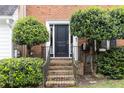 Inviting front entrance with brick steps, a sleek black door, and neatly trimmed landscaping at 911 Lenox Hill Ne Ct, Atlanta, GA 30324
