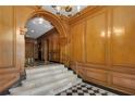 Grand staircase featuring marble steps, checkered flooring, and wood-paneled walls at 1325 Peachtree Ne St # 401, Atlanta, GA 30309