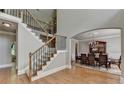 Spacious foyer featuring hardwood floors, a staircase, and a view of the dining room at 1875 Briergate Dr, Duluth, GA 30097