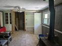 Spacious living room showing unfinished construction and featuring a ceiling fan and paneled walls at 2291 Piney Grove Rd, Loganville, GA 30052