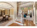 Inviting foyer with hardwood floors, staircase, and views into the living and dining areas at 4114 Suwanee Trail Dr, Buford, GA 30518