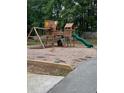 Community playground with a wooden play structure, slides, swings, and climbing features for enjoyment at 6397 Autumn View Nw Trce, Acworth, GA 30101