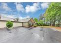 Exterior view of home with stone accents, a wide driveway, and an attached garage at 104 Highlands Ridge Se # 1, Smyrna, GA 30082