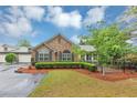 Charming home featuring stone accents, well-manicured landscaping, and an attached garage at 104 Highlands Ridge Se # 1, Smyrna, GA 30082