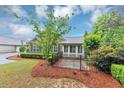Charming home with stone accents, manicured landscaping, and a cozy front patio enclosed by a black fence at 104 Highlands Ridge Se # 1, Smyrna, GA 30082