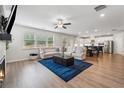 Spacious living room with hardwood floors, fireplace, and view into the bright, modern kitchen at 2091 Landsburg Way, Lawrenceville, GA 30043