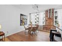Cozy dining area with a round table, four chairs, and natural light from large windows, next to the kitchen bar at 800 Peachtree Ne St # 8509, Atlanta, GA 30308