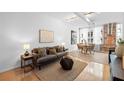 Inviting living room with hardwood floors, neutral tones, and exposed brick, providing a comfortable and stylish space at 800 Peachtree Ne St # 8509, Atlanta, GA 30308
