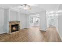 Inviting living room features a stone fireplace, hardwood floors, and an open layout leading to the kitchen at 1283 Mercer Ave, East Point, GA 30344