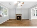 Bright living room with a cozy fireplace, hardwood floors, and large windows offering plenty of natural light at 1283 Mercer Ave, East Point, GA 30344