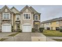 Traditional home with stone and siding, an attached garage, and manicured front lawn at 1963 Lakeshore Overlook Nw Cir, Kennesaw, GA 30152
