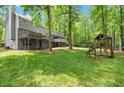 Spacious backyard featuring a wooden swing set and tree surround property at 2871 Liberty Ct, Marietta, GA 30066