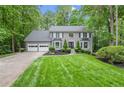 Landscaped front yard leading up to a two-story gray brick home with a two car garage at 2871 Liberty Ct, Marietta, GA 30066