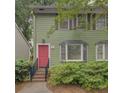Charming two-story home with a bright pink door and well-maintained landscaping at 6 Holly Downs Nw Ct, Atlanta, GA 30318