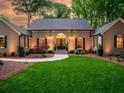 Inviting brick home with landscape lighting, manicured lawn and charming front entry at 4643 River Ct, Peachtree Corners, GA 30097