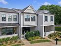 Charming townhome with beautifully landscaped front yard and covered porch at 677 Stickley Oak Way, Woodstock, GA 30189