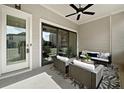 Comfortable covered patio with stylish seating and a ceiling fan for relaxing outdoors at 677 Stickley Oak Way, Woodstock, GA 30189