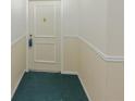 Hallway with neutral paint, white trim, and green patterned carpet at 6851 Roswell Rd # 0-26, Atlanta, GA 30328