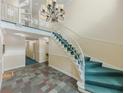 Inviting lobby area with stairs, tiled floor, chandelier, and neutral walls at 6851 Roswell Rd # 0-26, Atlanta, GA 30328