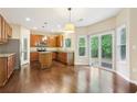 Eat-in kitchen featuring granite countertops, stainless appliances, and hardwood floors at 1647 Shire Village Dr, Sugar Hill, GA 30518