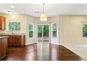 Bright breakfast area in kitchen with backyard views from the sliding glass door at 1647 Shire Village Dr, Sugar Hill, GA 30518