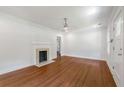 Spacious living room with hardwood floors, white walls, a modern ceiling fan and a decorative fireplace at 1798 S Gordon Sw St, Atlanta, GA 30310