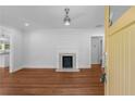 Bright living room features hardwood floors, ceiling fan, and a modern fireplace with shiplap accents at 1798 S Gordon Sw St, Atlanta, GA 30310