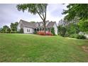 Beautiful home with lush green lawn and mature trees, set back from the road at 18 Spring Lake Ne Trl, White, GA 30184