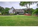 Charming home with manicured lawn, stone accents, and inviting front porch at 18 Spring Lake Ne Trl, White, GA 30184