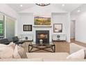 Cozy living room with a fireplace, comfortable seating, and large windows providing natural light at 3610 Burnt Bridge Rd, Cumming, GA 30028