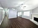 Spacious living room with a fireplace, ceiling fan, and wood-look floors at 3647 Diamond Cir, Decatur, GA 30034