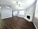 Bright living room with a ceiling fan, a fireplace, and a view of the kitchen at 3647 Diamond Cir, Decatur, GA 30034