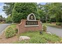 Edinburgh community sign surrounded by lush greenery, enhancing the neighborhood's appeal at 5293 Aldeburgh Dr, Suwanee, GA 30024