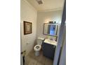 Small bathroom features white subway tile, blue vanity, framed art, and neutral-colored floors at 1151 Rankin St # 2B, Stone Mountain, GA 30083