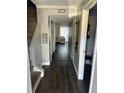 Inviting hallway features hardwood floors, neutral paint, and leads to a cozy bedroom at 1151 Rankin St # 2B, Stone Mountain, GA 30083