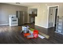 Spacious living room and kitchen area with stainless steel appliances and new flooring at 1151 Rankin St # 7A, Stone Mountain, GA 30083