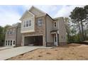 Newly built two-story house with a two-car garage and driveway on a sunny day, still under construction at 1954 William Glen St, Dacula, GA 30019