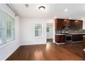 Bright living room featuring hardwood floors, large windows, and an open kitchen with stainless steel appliances at 2308 Scotty Cir, Decatur, GA 30032