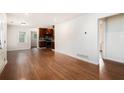 Open concept living room with hardwood floors and kitchen with dark cabinets and stainless steel appliances at 2308 Scotty Cir, Decatur, GA 30032