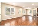 Spacious living room featuring gleaming hardwood floors, large windows, and a welcoming front door at 2308 Scotty Cir, Decatur, GA 30032