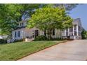 Beautiful home with a lush green lawn, mature trees, and a welcoming driveway at 26 Kensington Rd, Avondale Estates, GA 30002