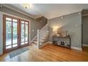 Elegant home entrance with hardwood floors, decorative lighting, and a staircase at 26 Kensington Rd, Avondale Estates, GA 30002