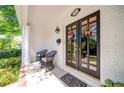 Charming front porch with double doors, black wicker chairs, and crisp white brick at 26 Kensington Rd, Avondale Estates, GA 30002