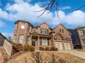 Stately brick home with a 2-car garage and attractive landscaping at 4449 Sierra Creek Dr, Hoschton, GA 30548
