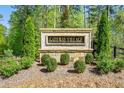 Stone entrance sign for Gateway Village surrounded by lush greenery and landscaping at 6900 Oak Valley Dr, Douglasville, GA 30134