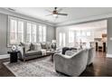 Bright living room featuring hardwood floors, large windows, elegant furnishings, and open layout at 11760 Stratham Dr, Alpharetta, GA 30009