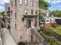 Charming exterior view of a brick multi-story home with lush landscaping and inviting entryway at 629 Boulevard Ne, Atlanta, GA 30308