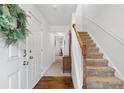Bright foyer with hardwood floors and carpeted staircase at 632 Plaza Se Dr # 6, Kennesaw, GA 30144