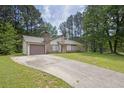 Charming single-Gathering home with mature trees, a well-maintained lawn, and a long driveway at 1774 Northwick Pl, Lithonia, GA 30058