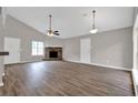 Living area features hardwood flooring, brick fireplace, and abundant natural light at 1774 Northwick Pl, Lithonia, GA 30058